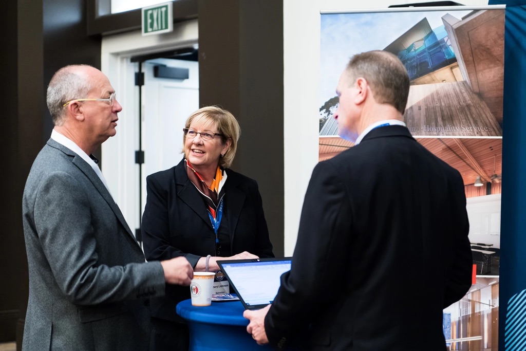 3 colleagues networking at a conference